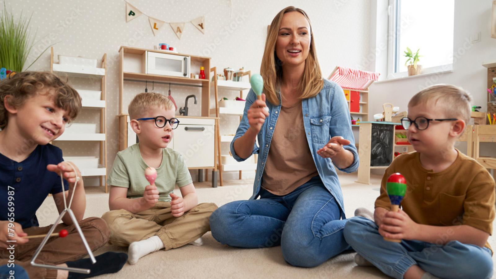 Teacher with children playing percussion instruments-Adobe stock photo